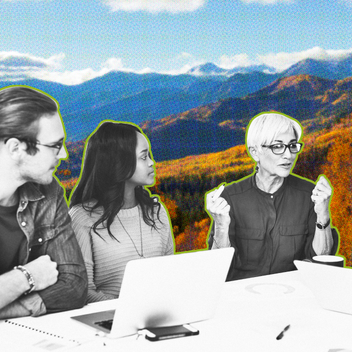 Group of diverse professionals sitting at a desk evaluating DXP together